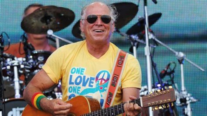 Jimmy Buffett wearing a t-shirt of his dogs